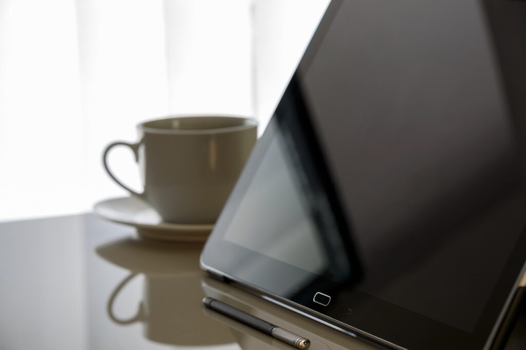 Tablet and coffee cup on a desk